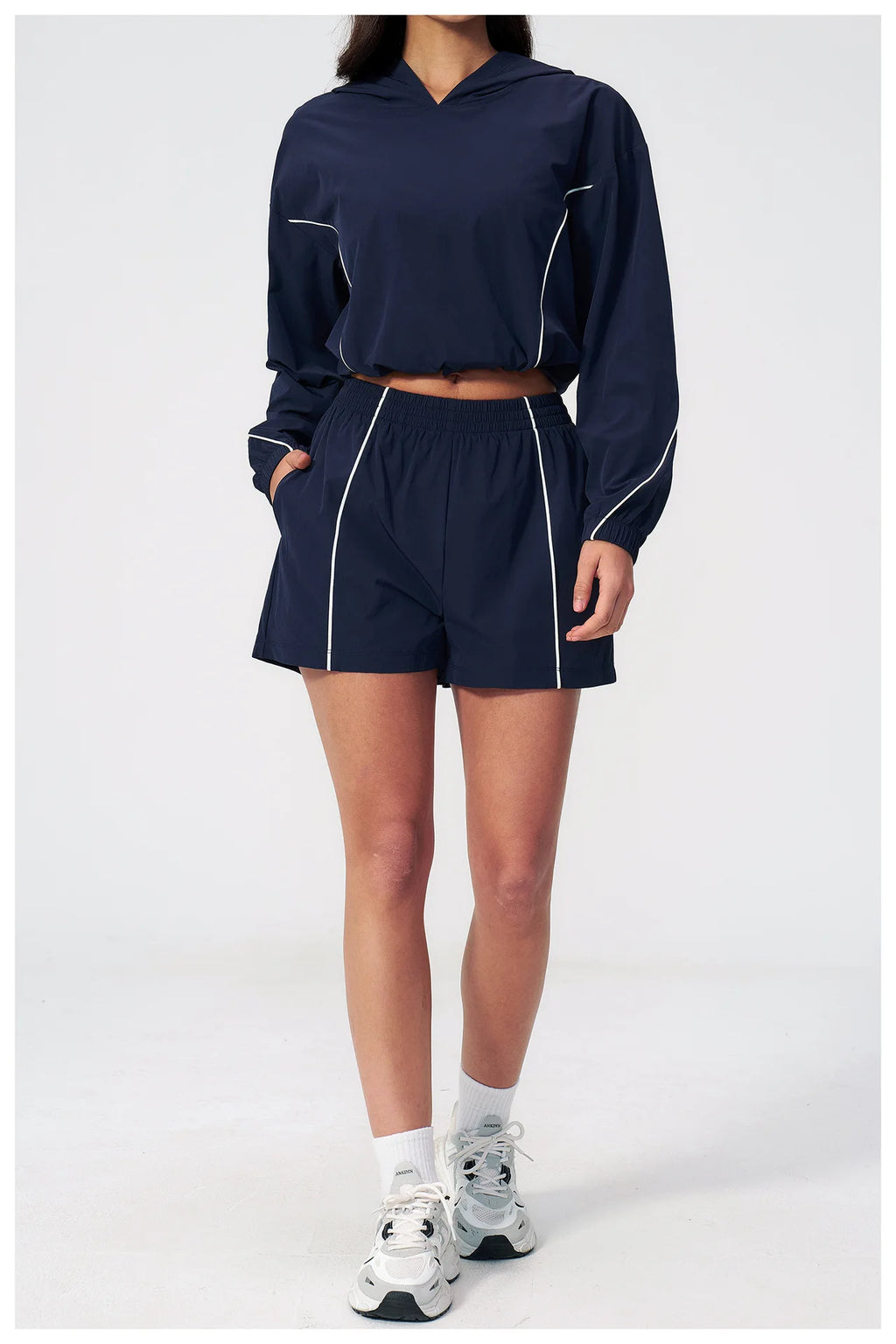 Navy hooded windbreaker top and matching athletic shorts set, long sleeves, elastic waist