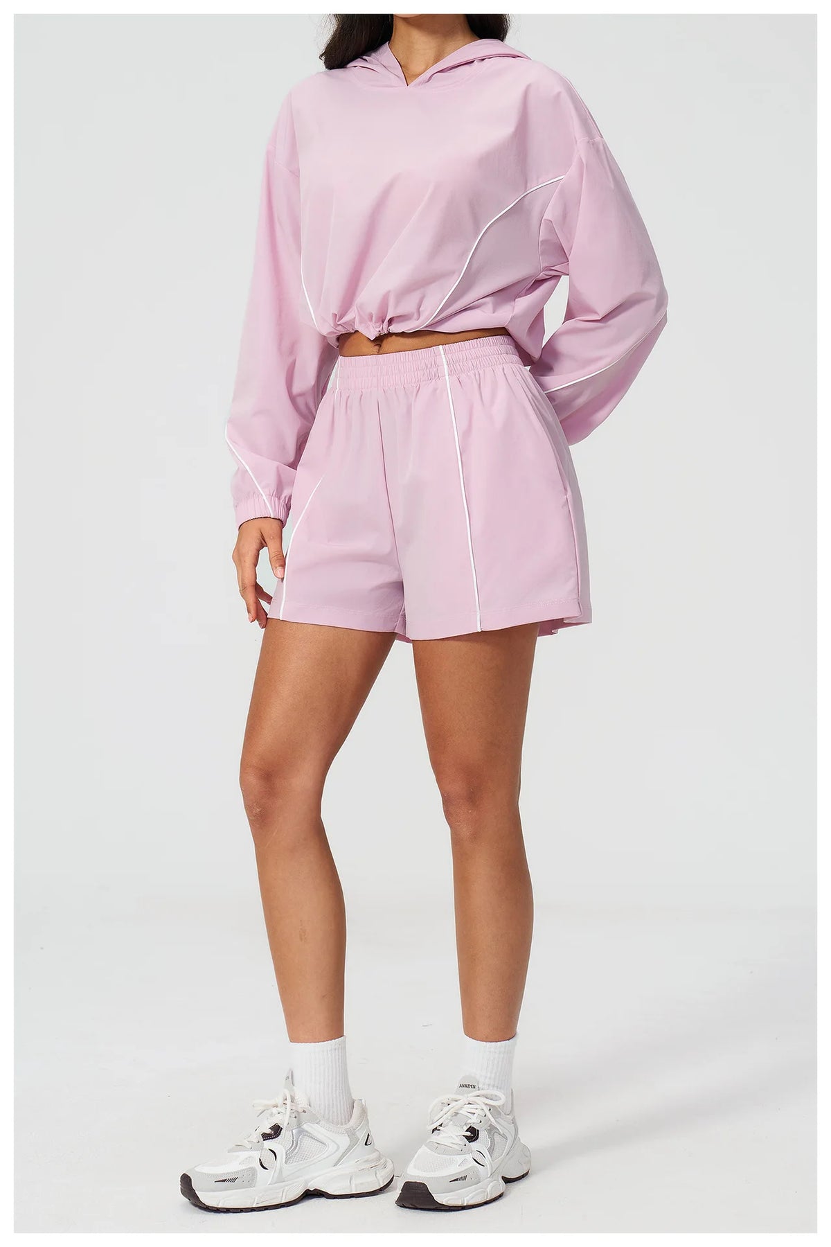 Pink hooded windbreaker top and matching shorts set, side/back view, elastic waistband
