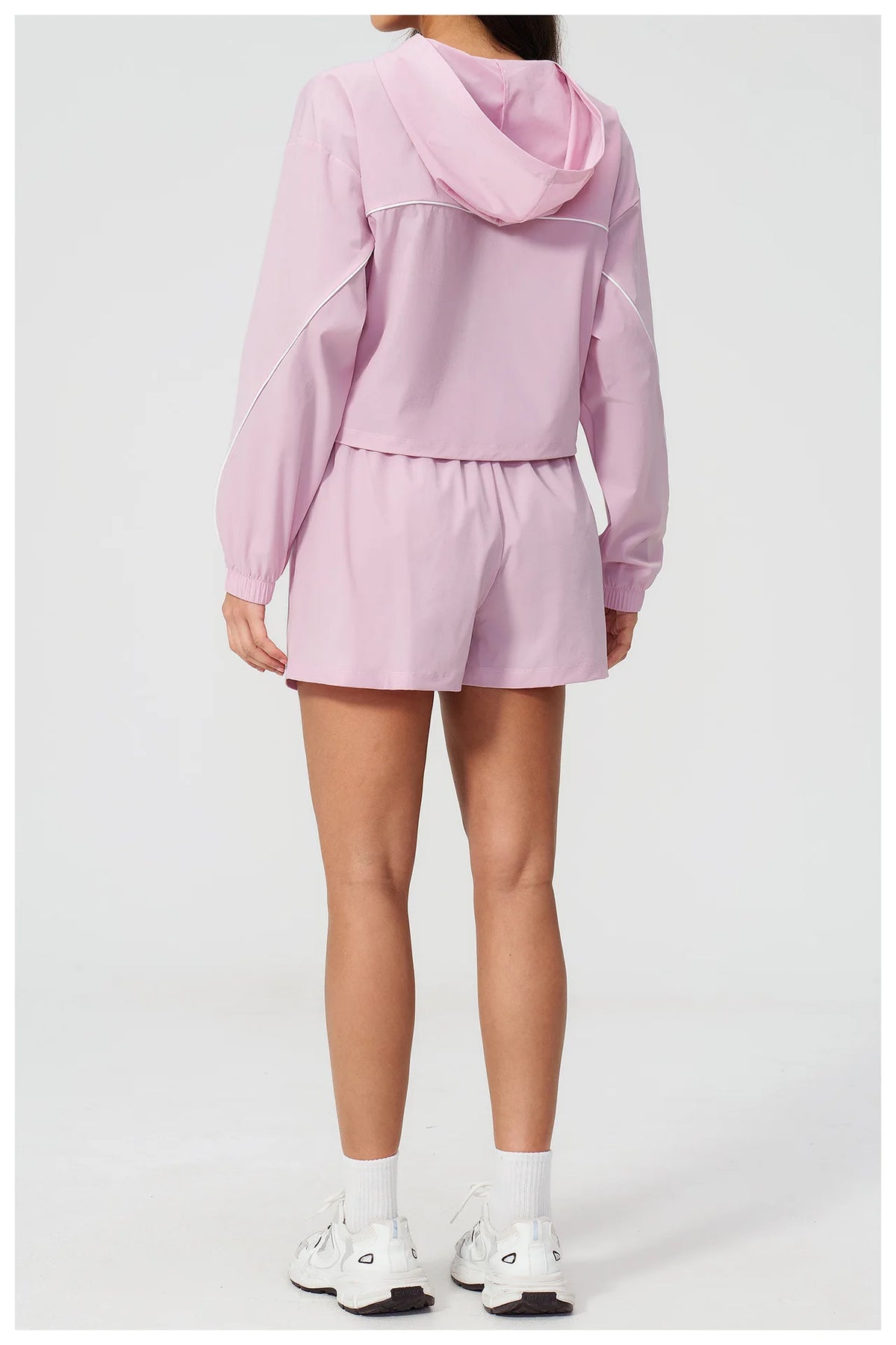 Pink hooded windbreaker top and matching shorts set from back view, elastic waist