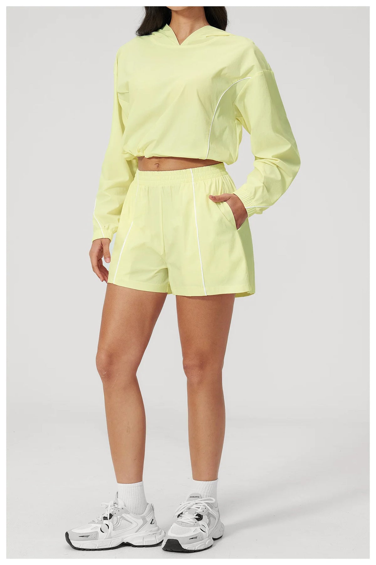Women’s hooded sports set, light yellow cropped jacket and matching drawstring shorts