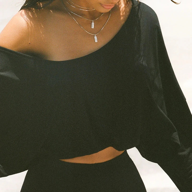 Xooie Fit black baggy crop top for workouts with an off-shoulder design and relaxed fit