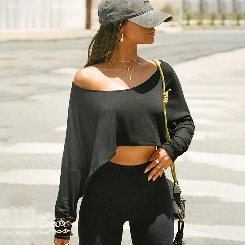 Xooie Fit black baggy crop top for workouts with off-shoulder design and stylish accessories