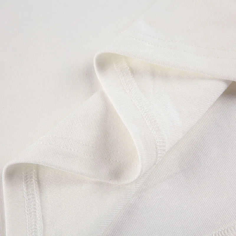 White Xooie Fit baggy crop top for workouts with soft fabric and a relaxed fit