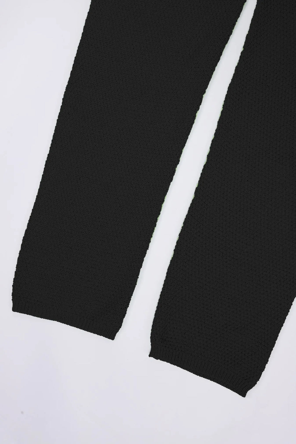 Black knit wide-leg romper hem and leg opening
