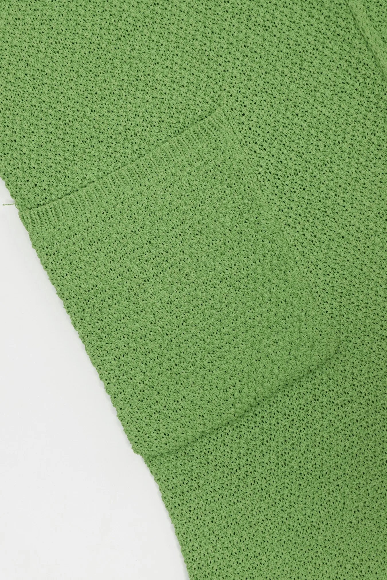 Onion green textured knit fabric close-up