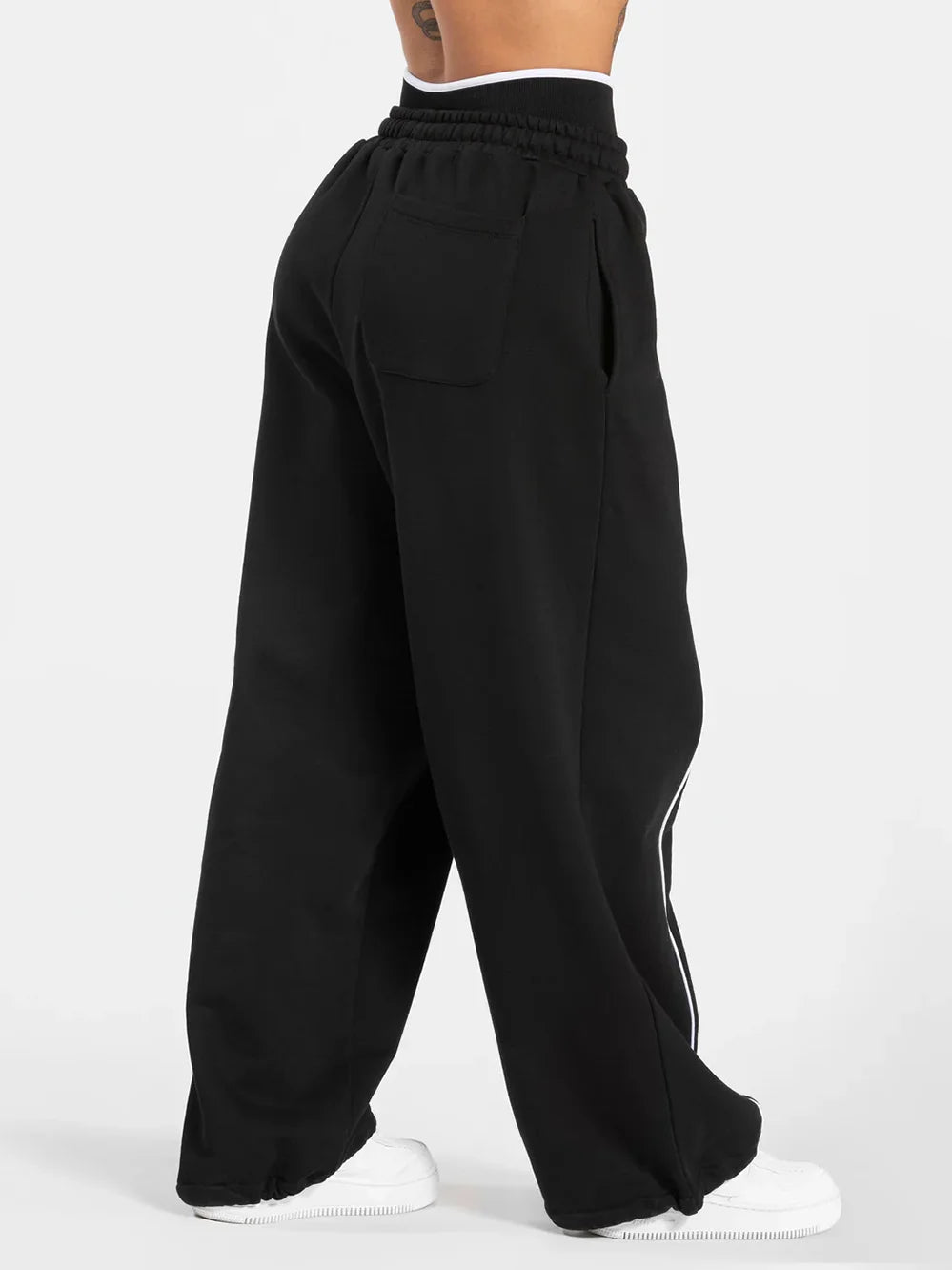 Baggy sweat joggers in black, wide leg with elastic waistband and white side stripe