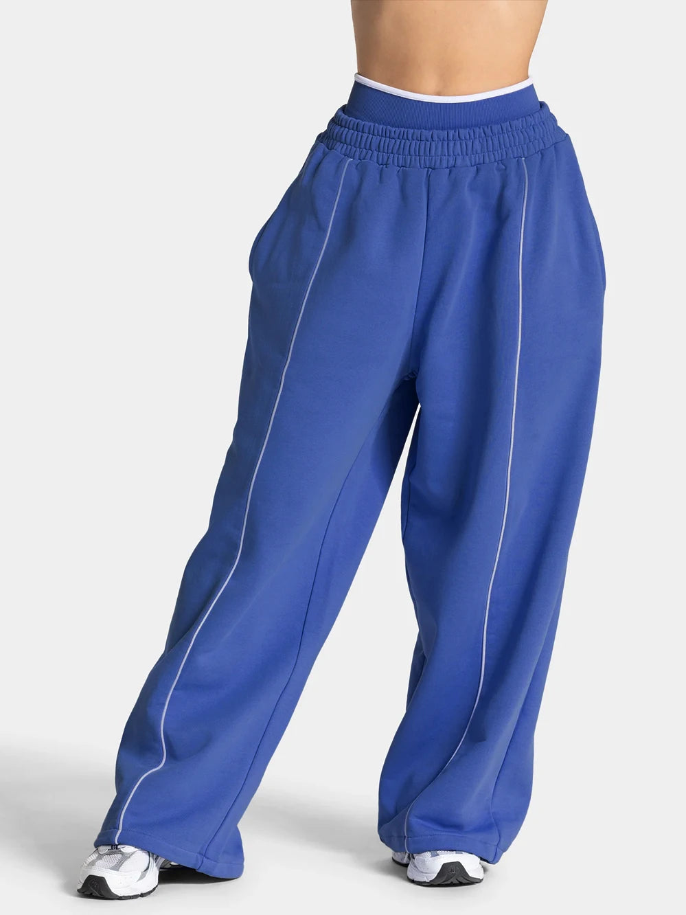 Baggy sweat joggers in blue with elastic waistband and white vertical side stripe
