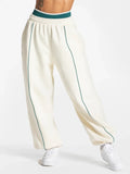 Baggy active joggers in white with teal side stripe and elastic waist
