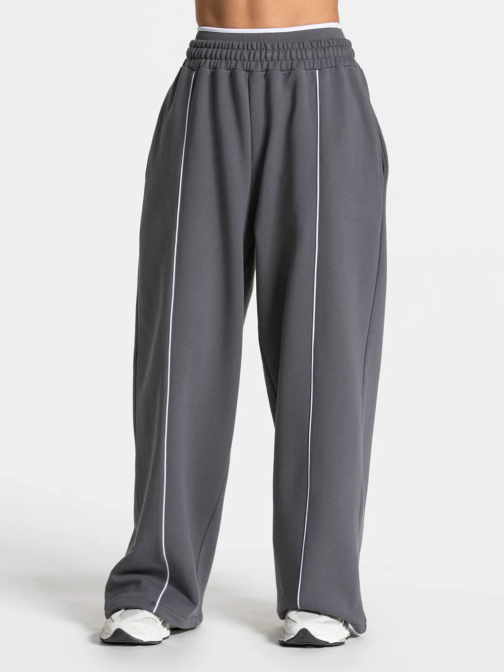 Baggy sweat joggers in dark gray with elastic waistband and white vertical side stripe