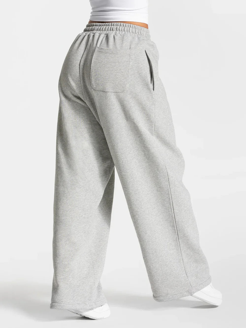 Baggy active joggers in light gray with elastic waistband and front patch pocket