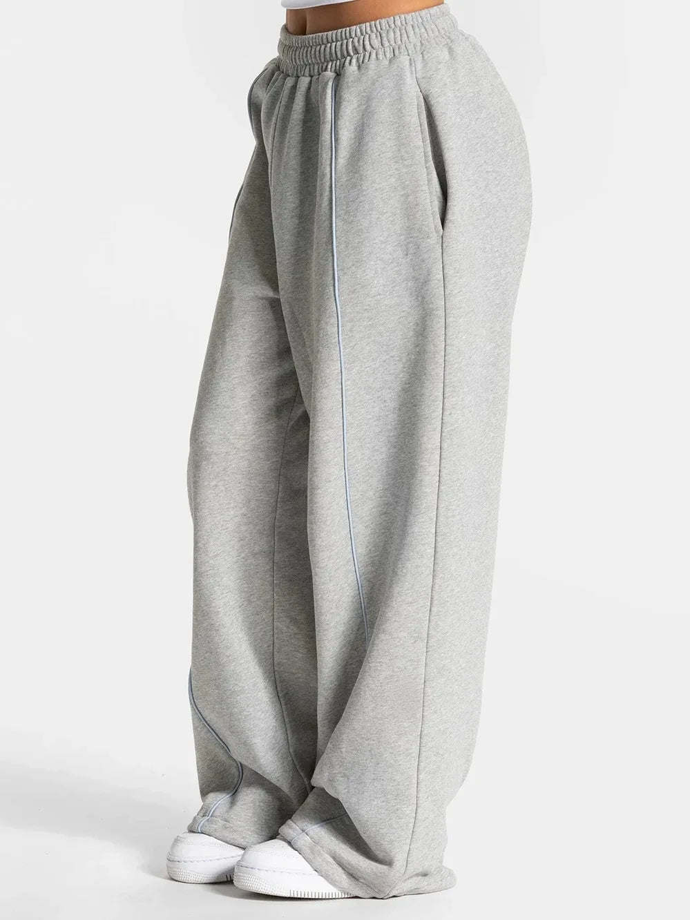 Baggy sweat joggers in light gray with elastic waistband and white vertical side stripe