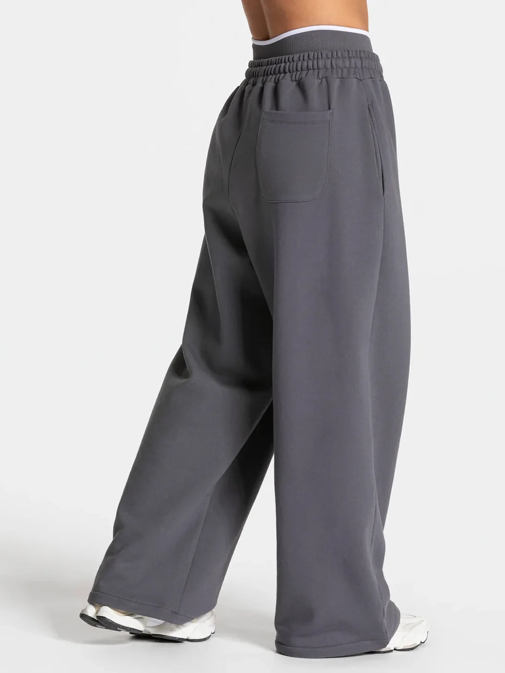 Baggy active joggers in dark gray with elastic waistband and back pockets