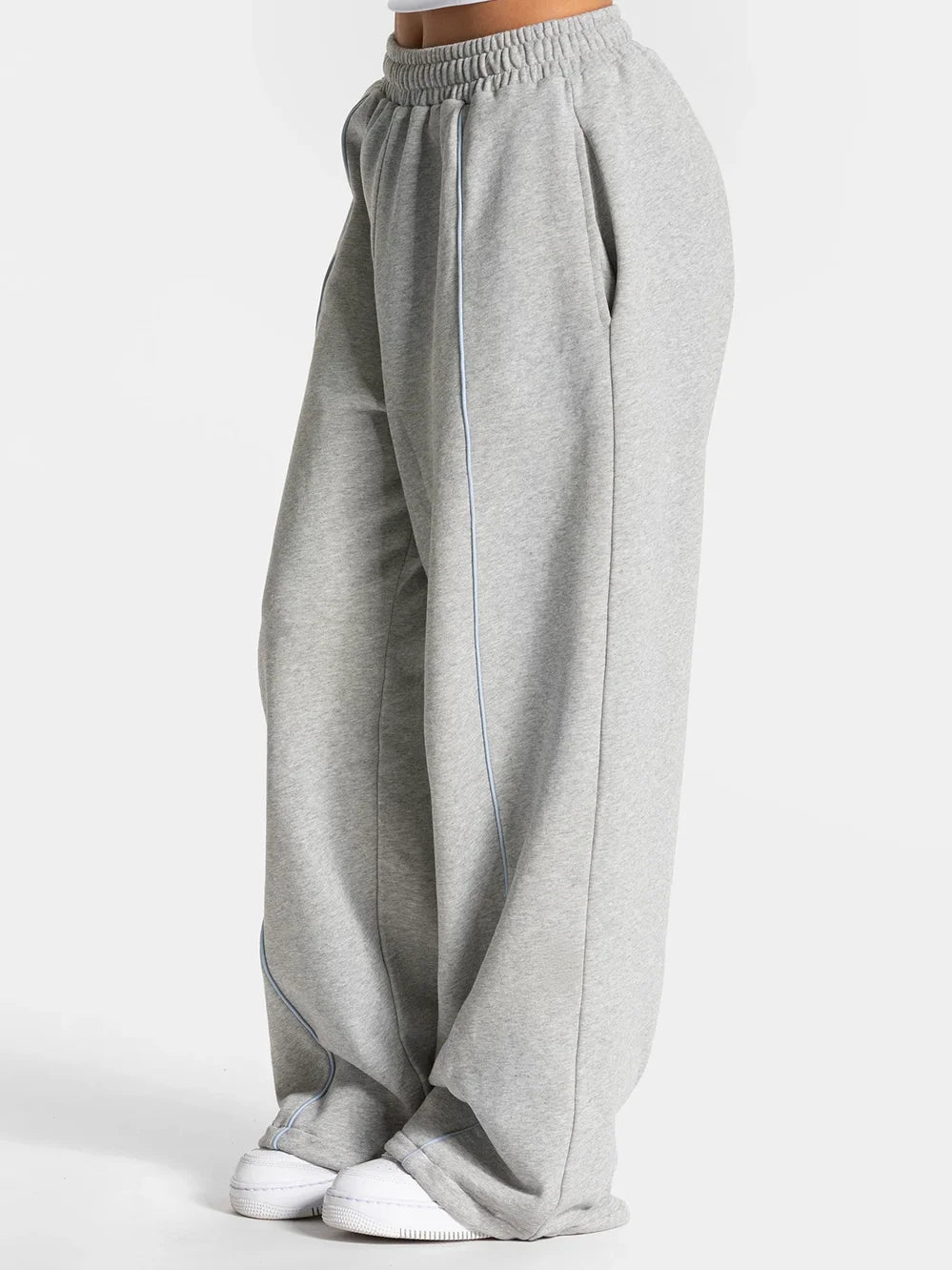 Baggy active joggers in light gray with elastic waist and blue side stripe