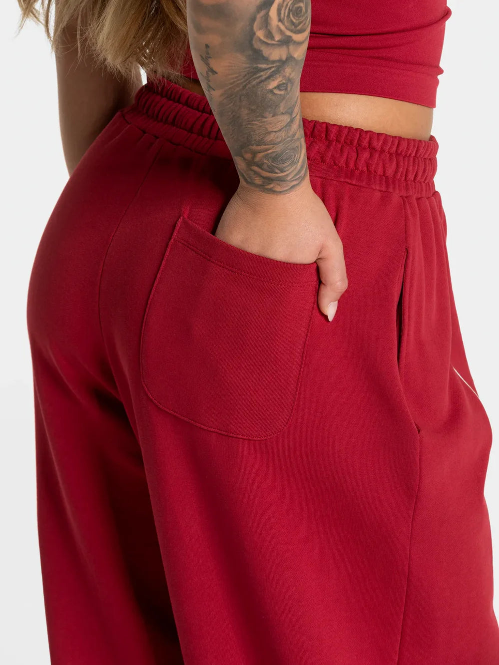 Maroon baggy active joggers with elastic waist and front patch pocket