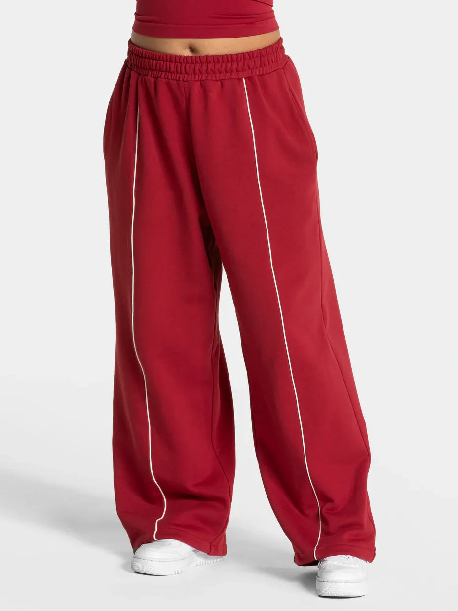Baggy sweat joggers in maroon with elastic waistband and white vertical side stripe