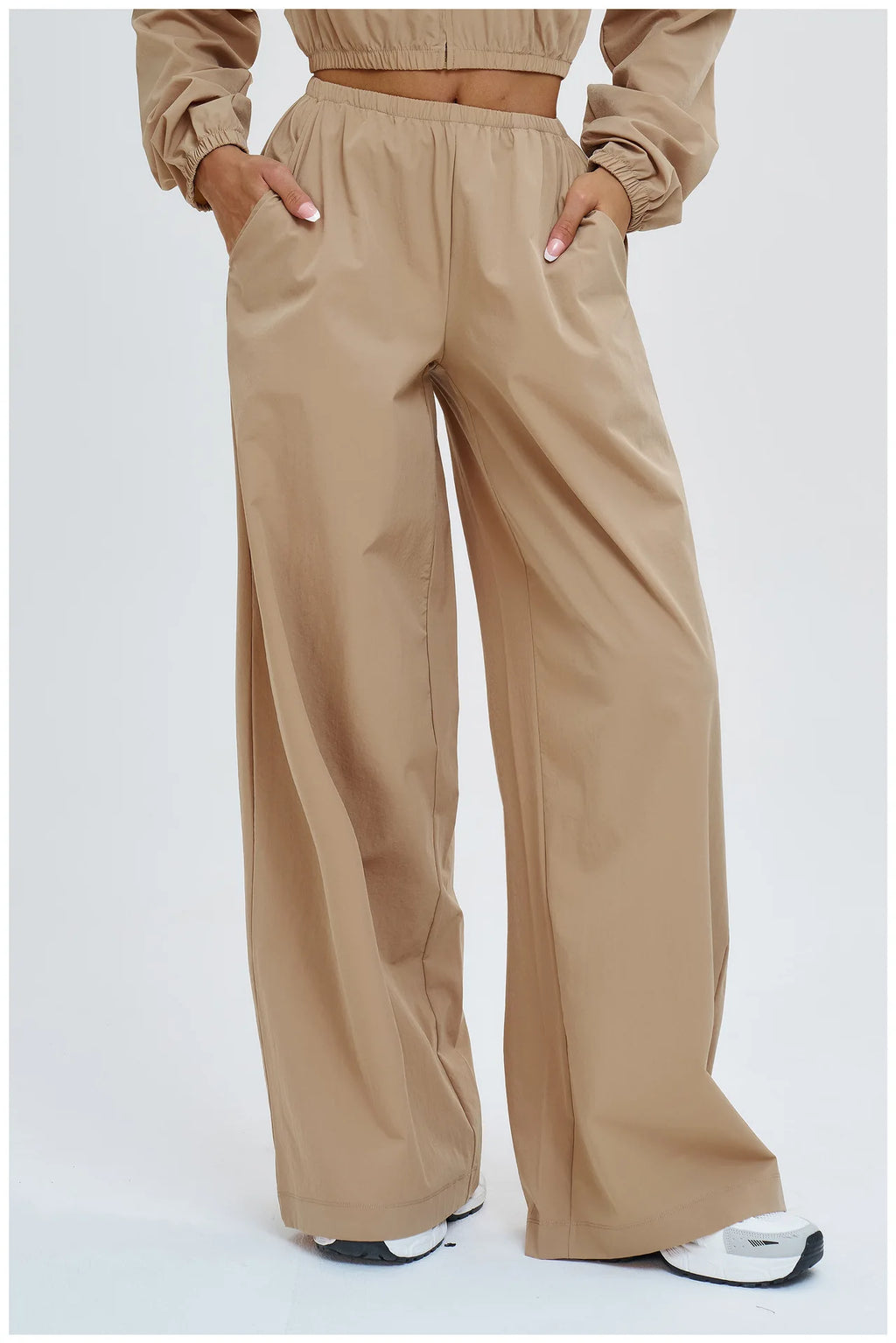 Women’s latte brown wide-leg pants with elastic waist and flowing straight legs.