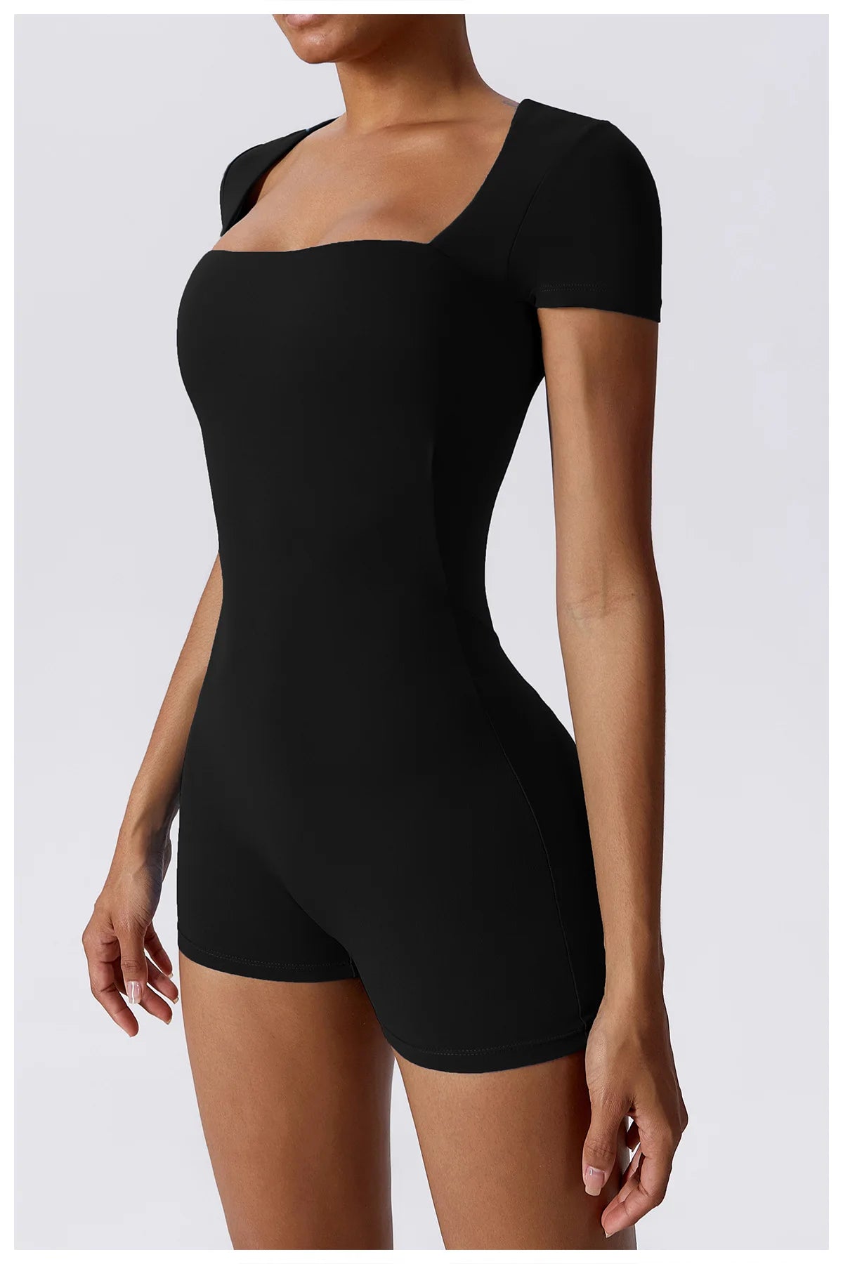 Women's black short one-piece yoga suit, front view with square neckline