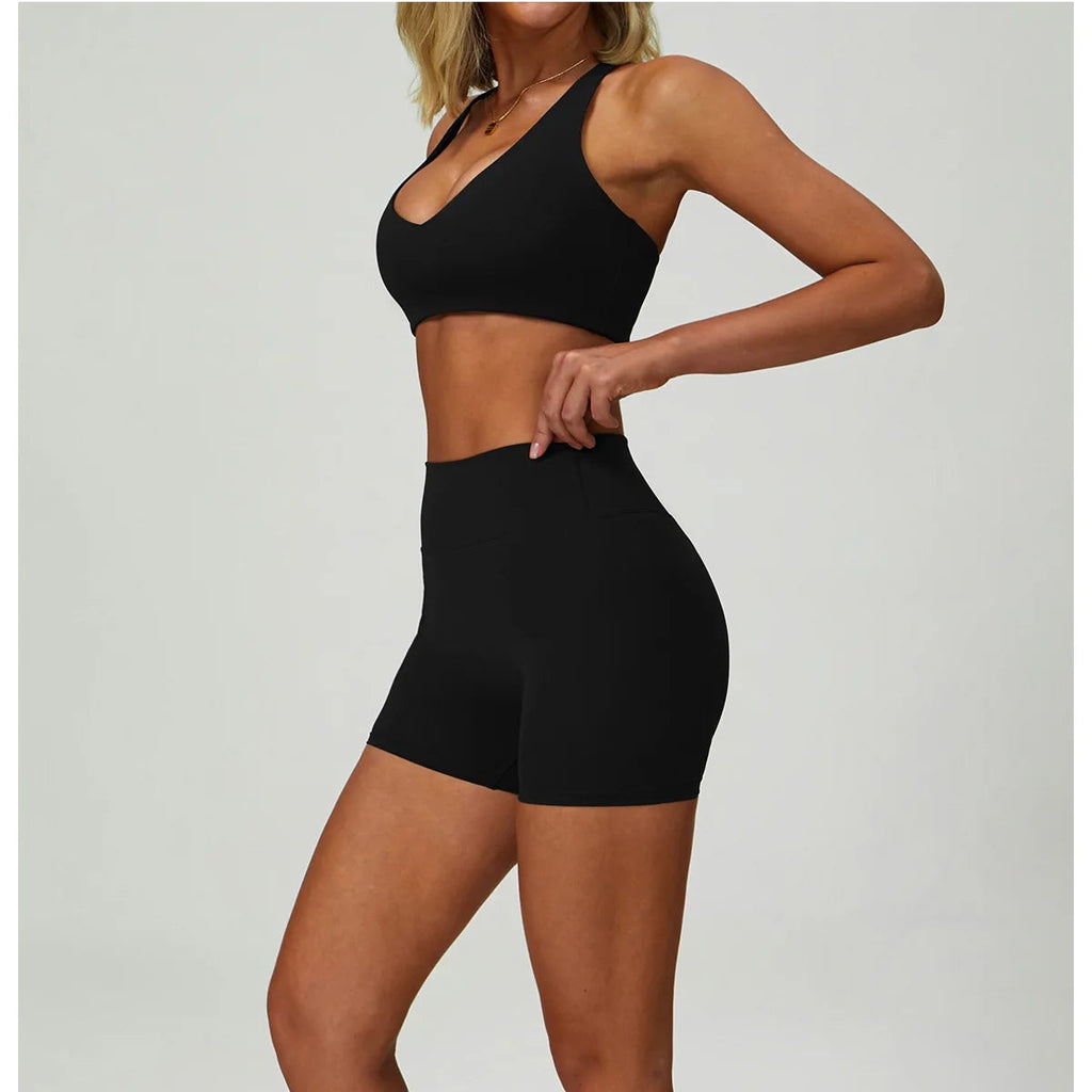 Black sports bralette and high-waisted active shorts set, front view