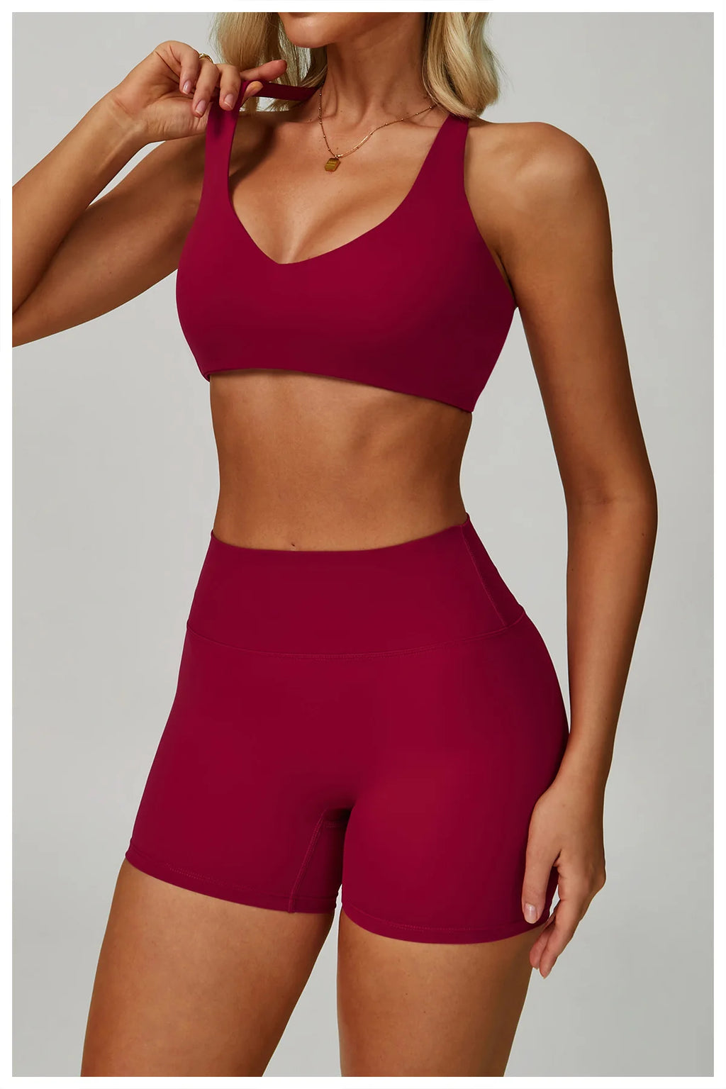 Rose red sports bralette and high-waisted active shorts matching set, front