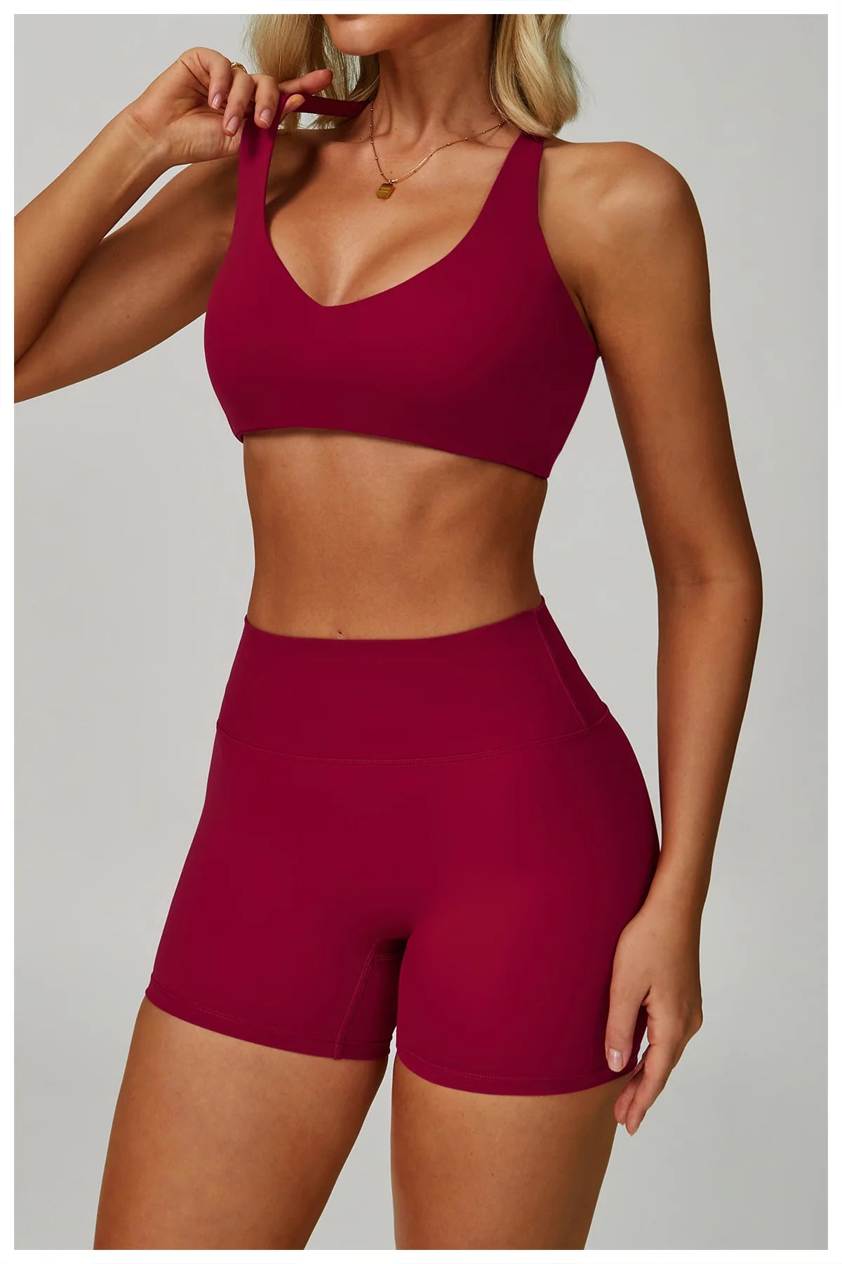 Rose red sports bralette and high-waisted active shorts matching set, front