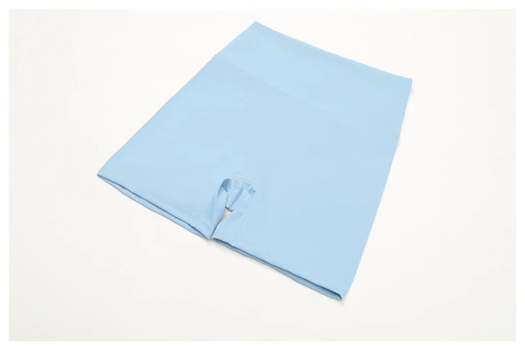 Crystal Blue high-waisted active shorts with center seam, flat lay