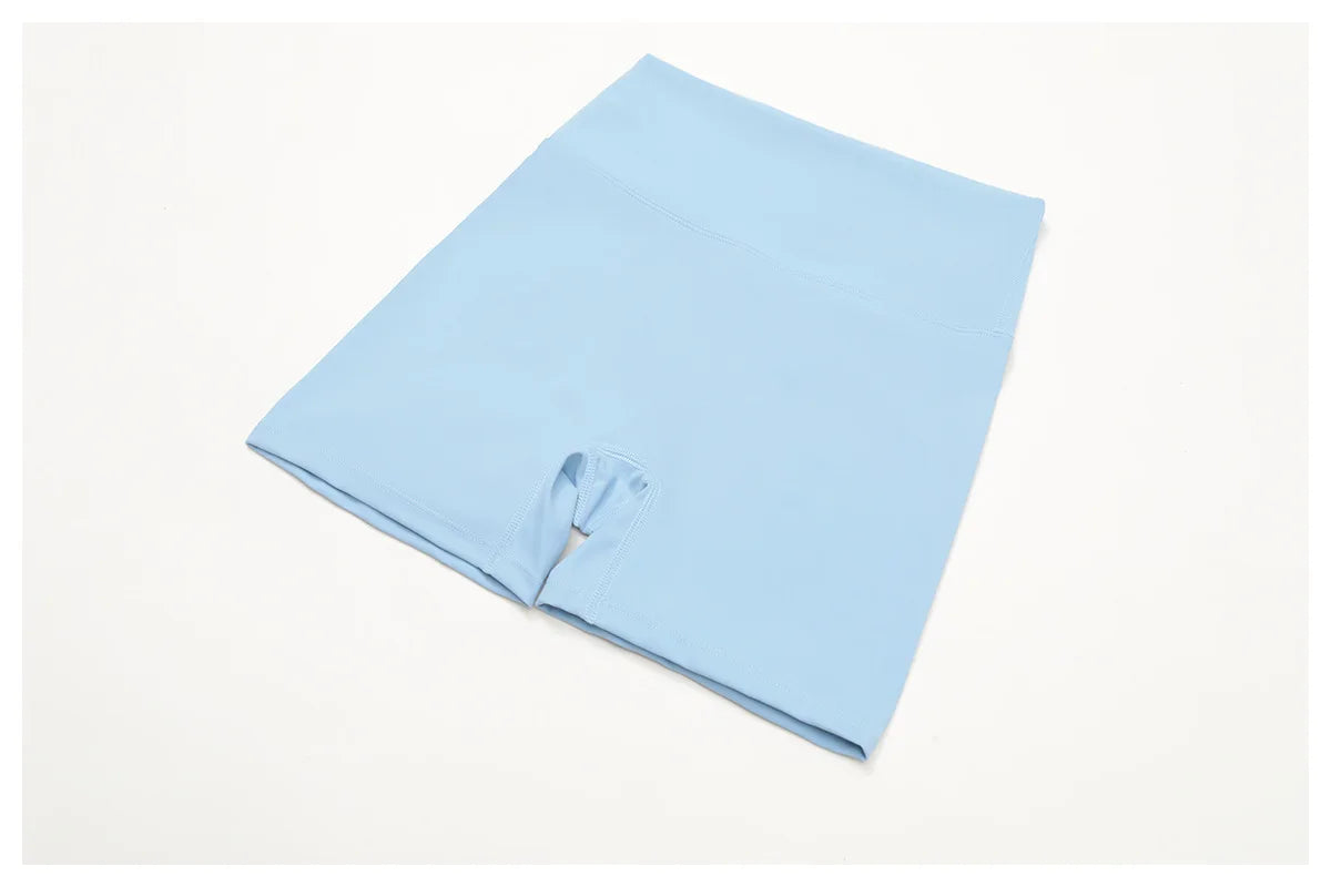 Crystal Blue high-waisted active shorts with center seam, flat lay