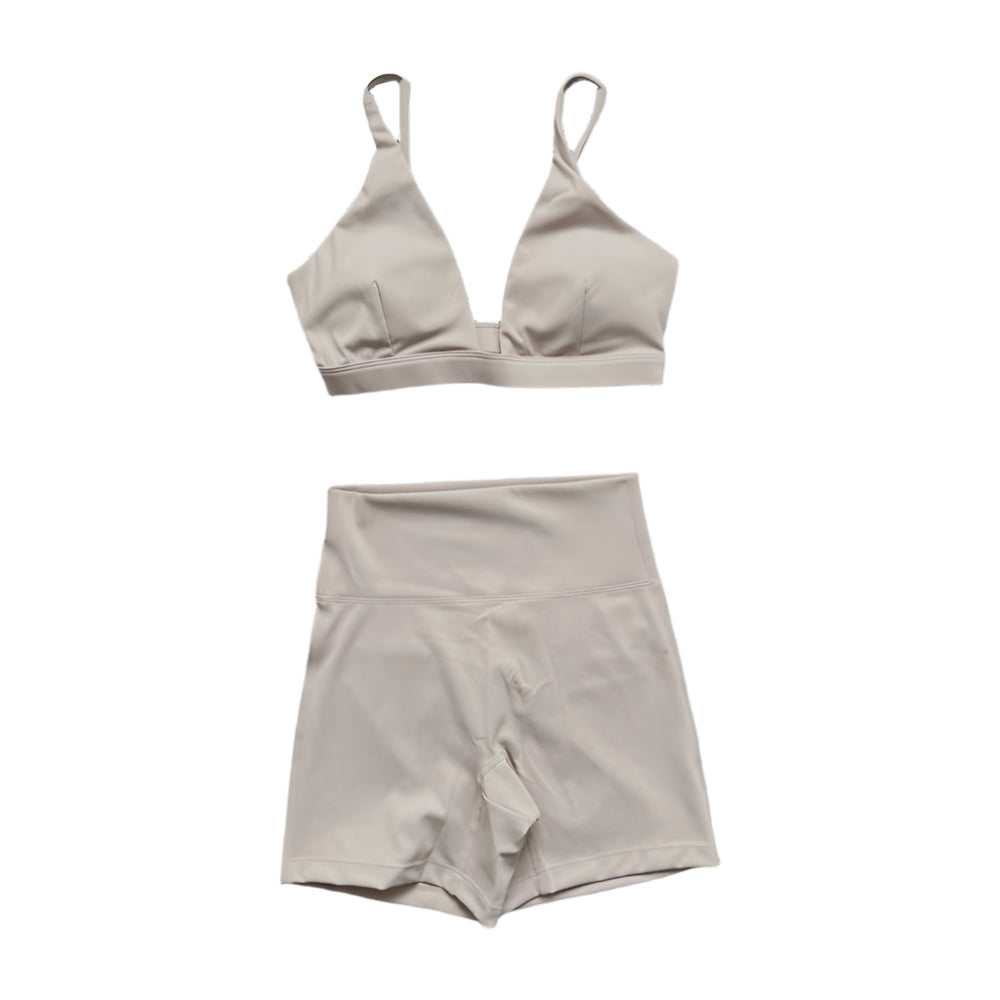 Light beige matching set: triangle bralette and high-waisted shorts.