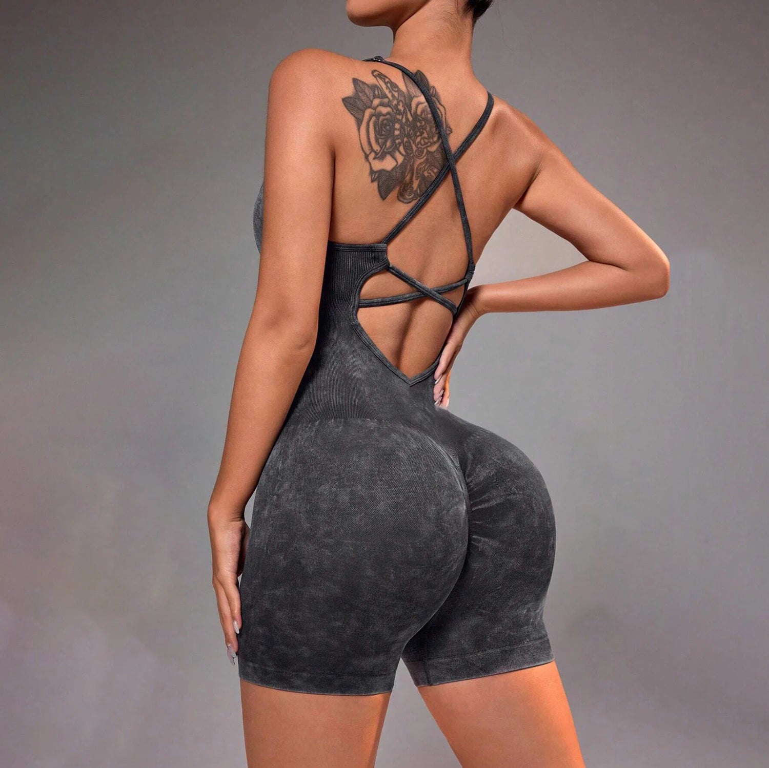 Distressed washed yoga bodysuit with strappy open-back one-piece short, dark gray