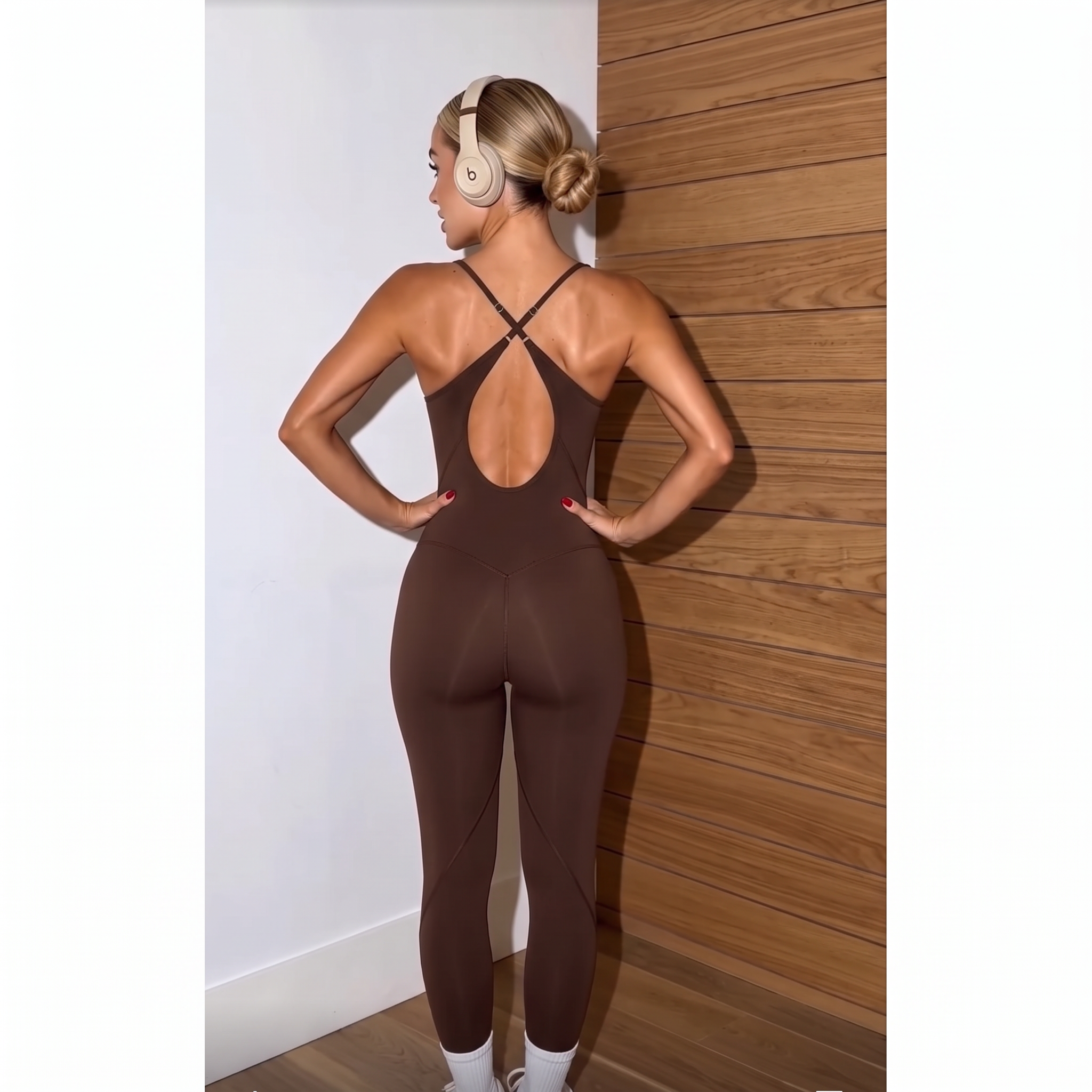 Brown fitted jumpsuit with criss-cross open-back straps and center back cutout