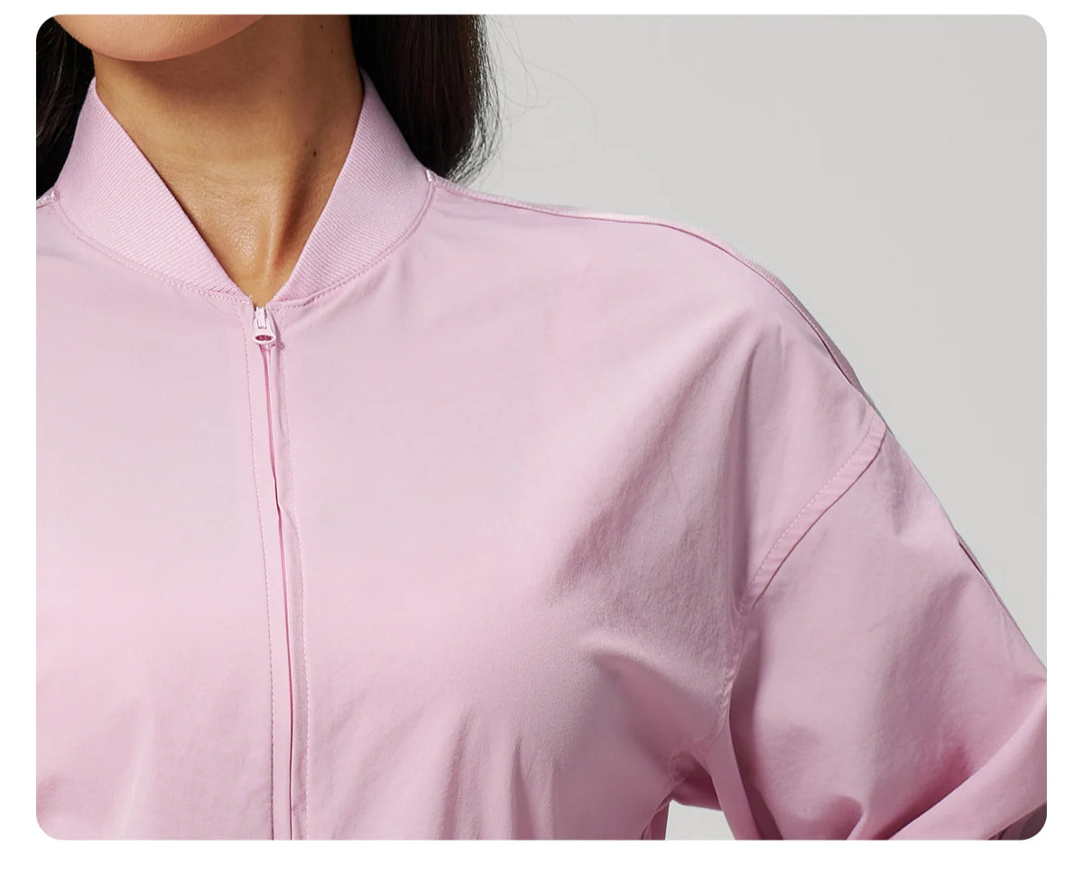 Lilac pink zip-front jacket fabric close-up with stand collar and zipper