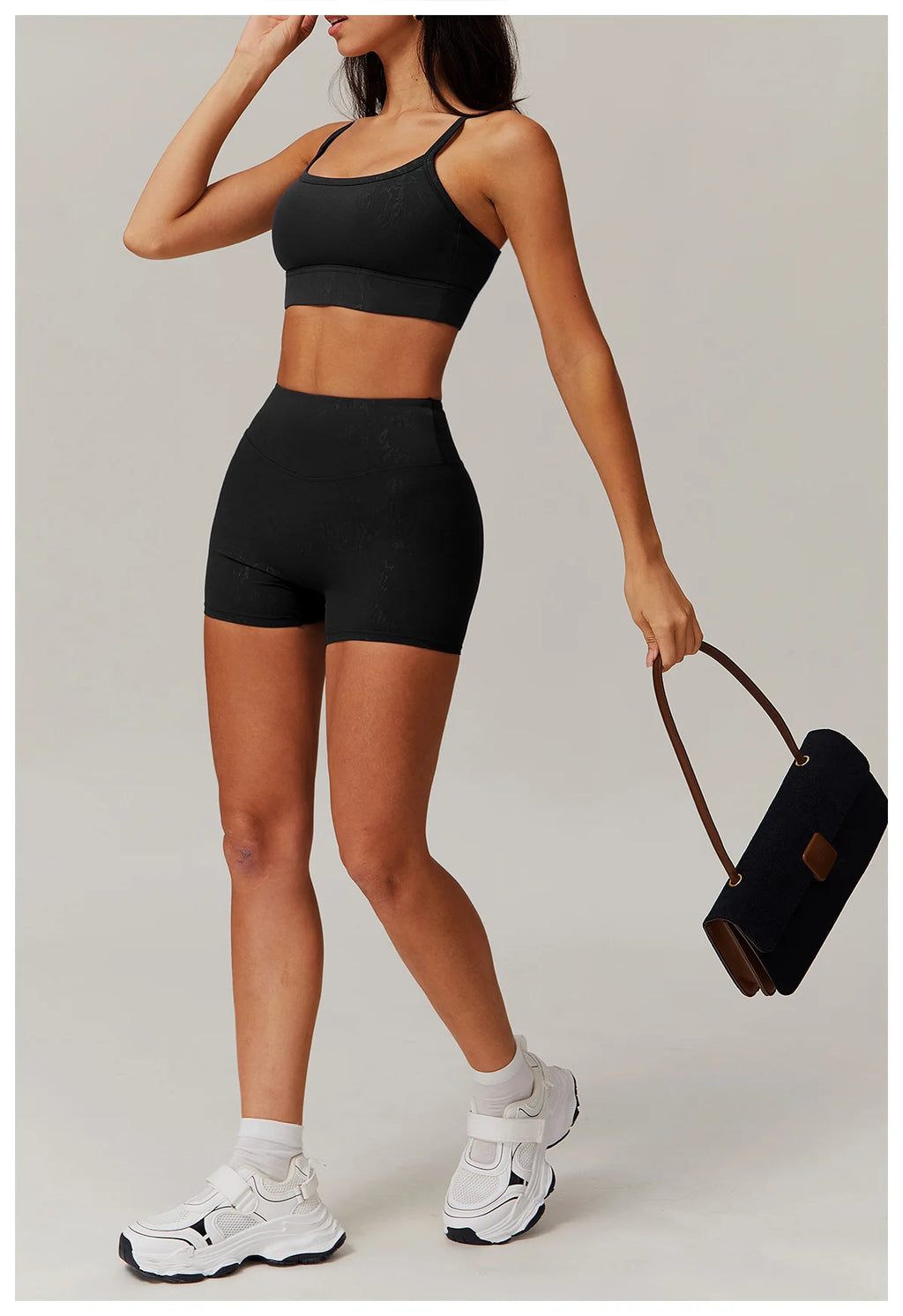 Black spaghetti-strap crop top and high-waisted shorts active set, front view