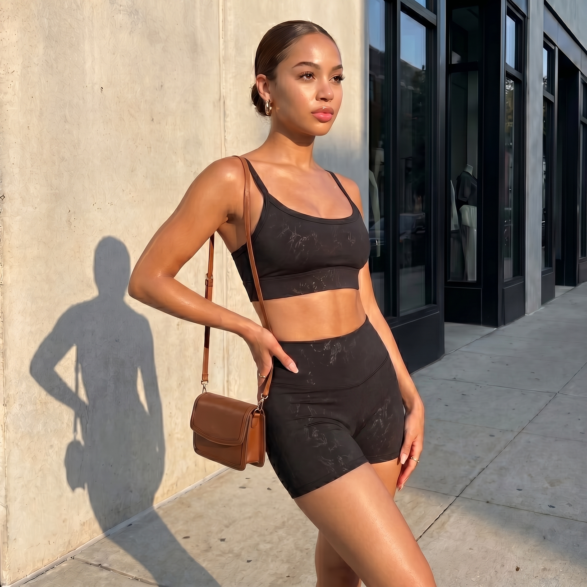 Black spaghetti-strap crop top and high-waisted shorts active set, matching set