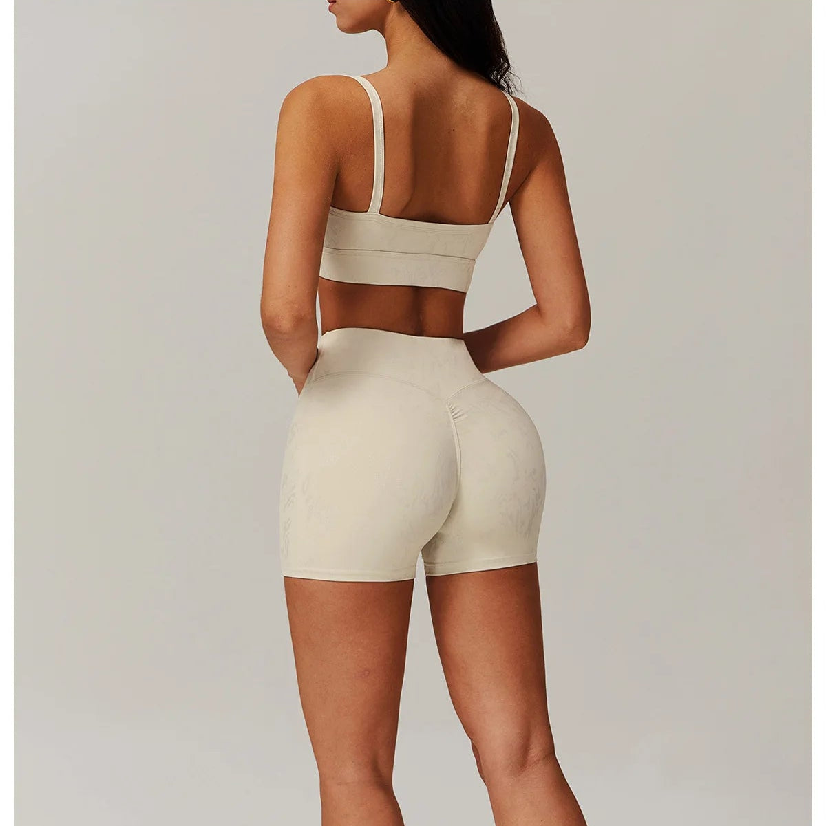 Ivory spaghetti-strap crop top and high-waisted shorts active set, back view