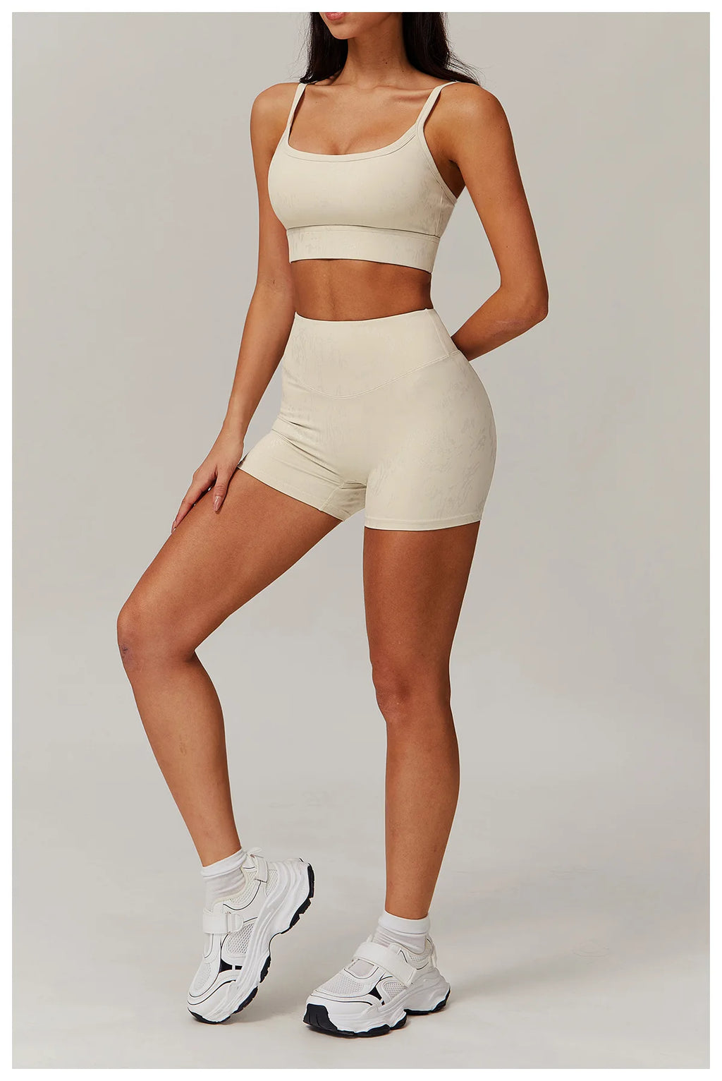 Ivory spaghetti-strap crop top and high-waisted shorts active set, front view