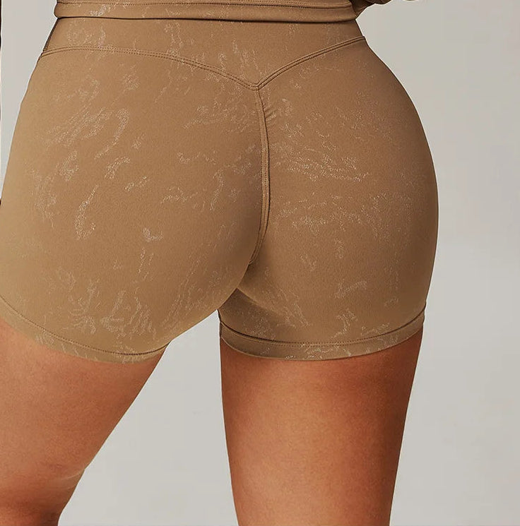 Light brown high-waisted shorts with fitted waistband, close-up