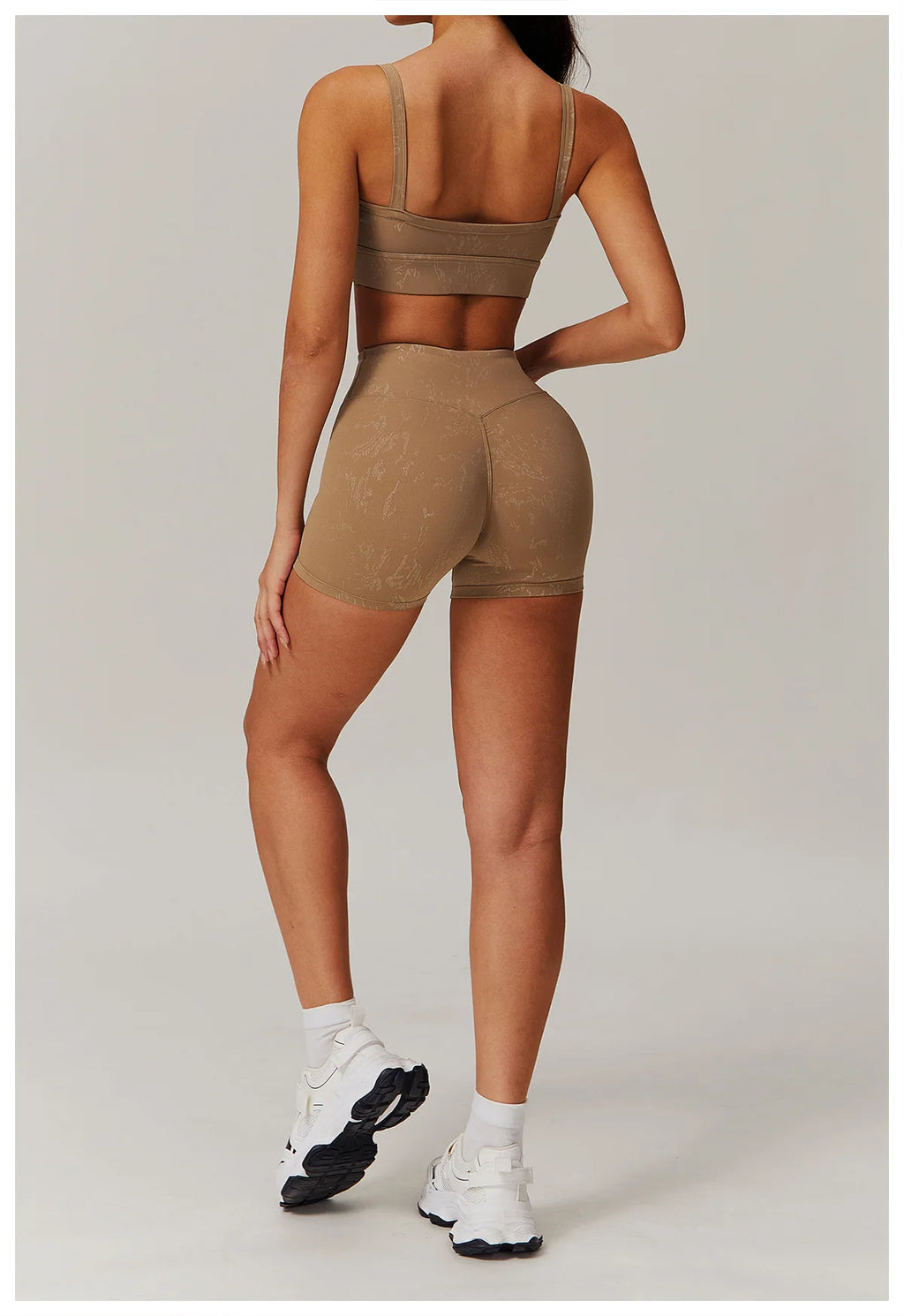 Light brown spaghetti-strap crop top and high-waisted shorts active set, side/back view