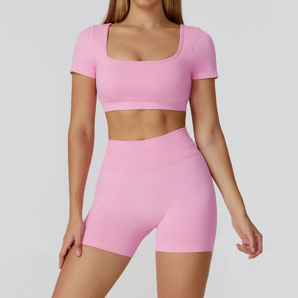 Pink backless crop top and high-waisted shorts matching active set