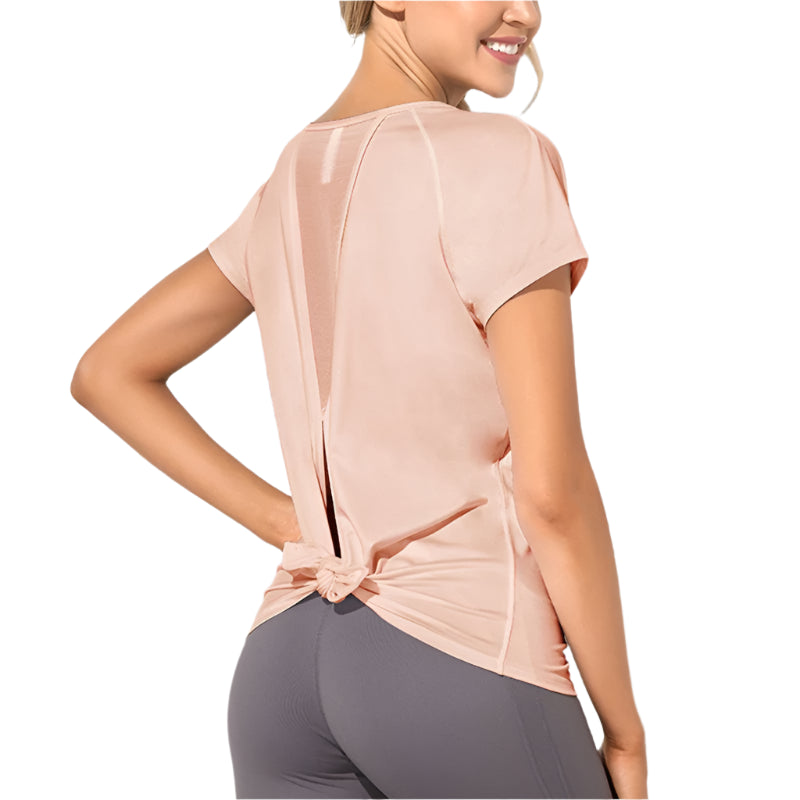 Xooie Fit dovetail split workout shirt in light pink with back mesh panels and knot detail