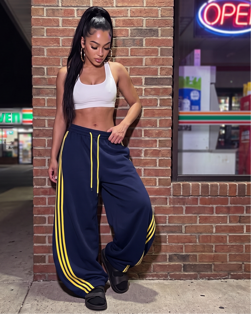 Navy oversized wide-leg sweatpants with drawstring and yellow side stripe accents