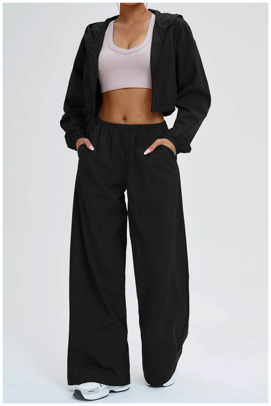 Women’s black wide-leg sports pants with relaxed fit and elastic waist.