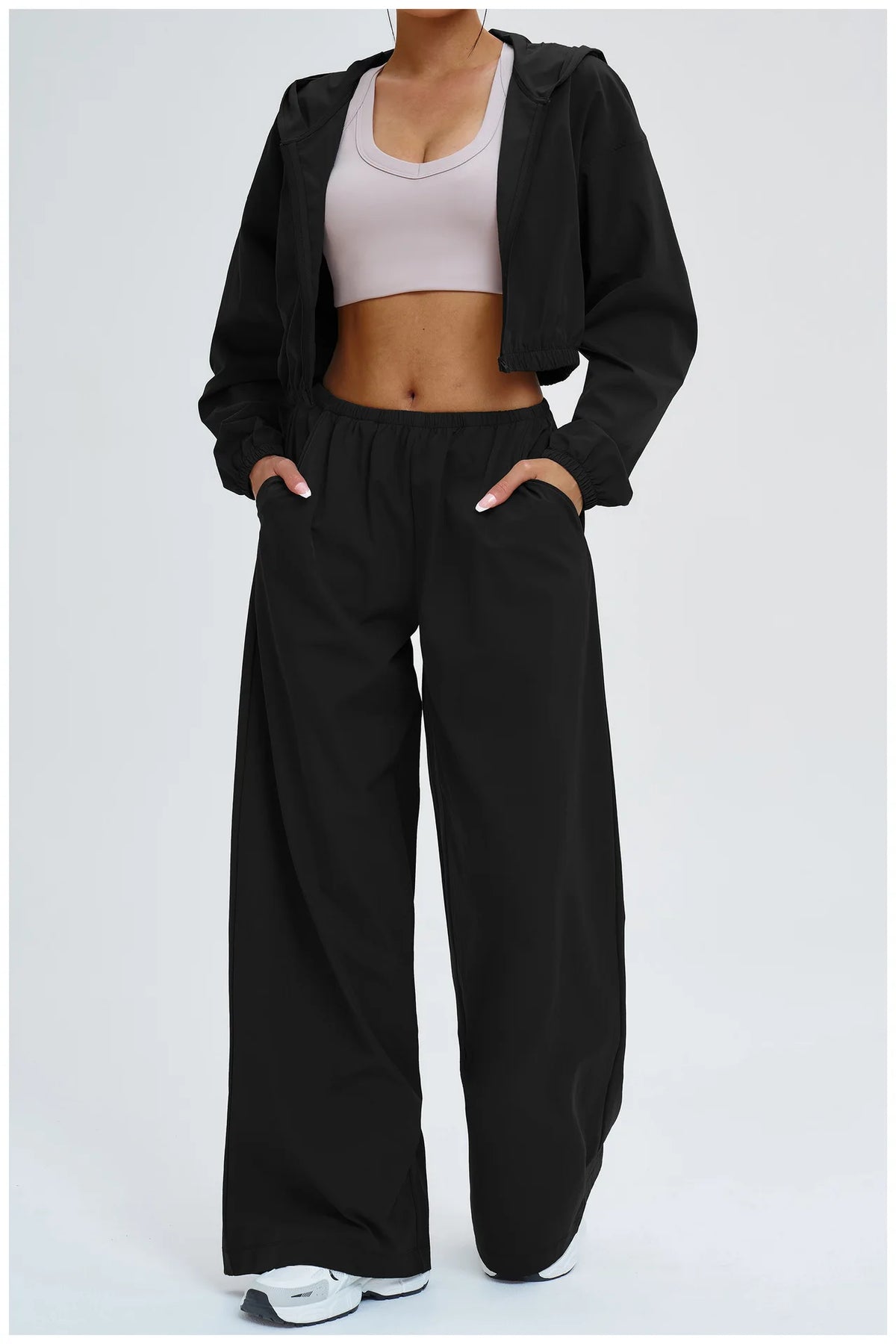 Women’s black wide-leg sports pants with relaxed fit and elastic waist.