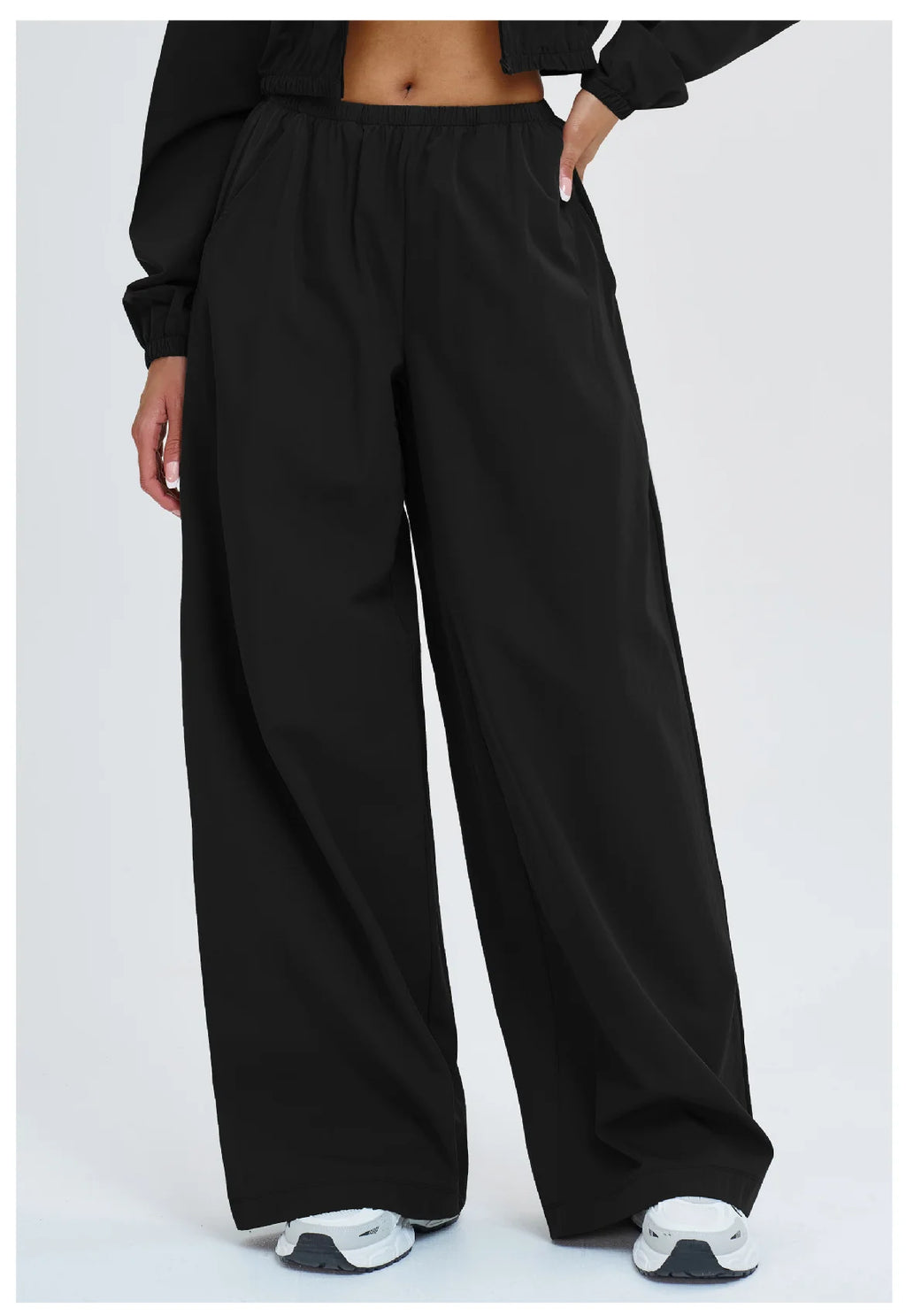 Women’s loose wide-leg yoga pants in black with elastic waistband.