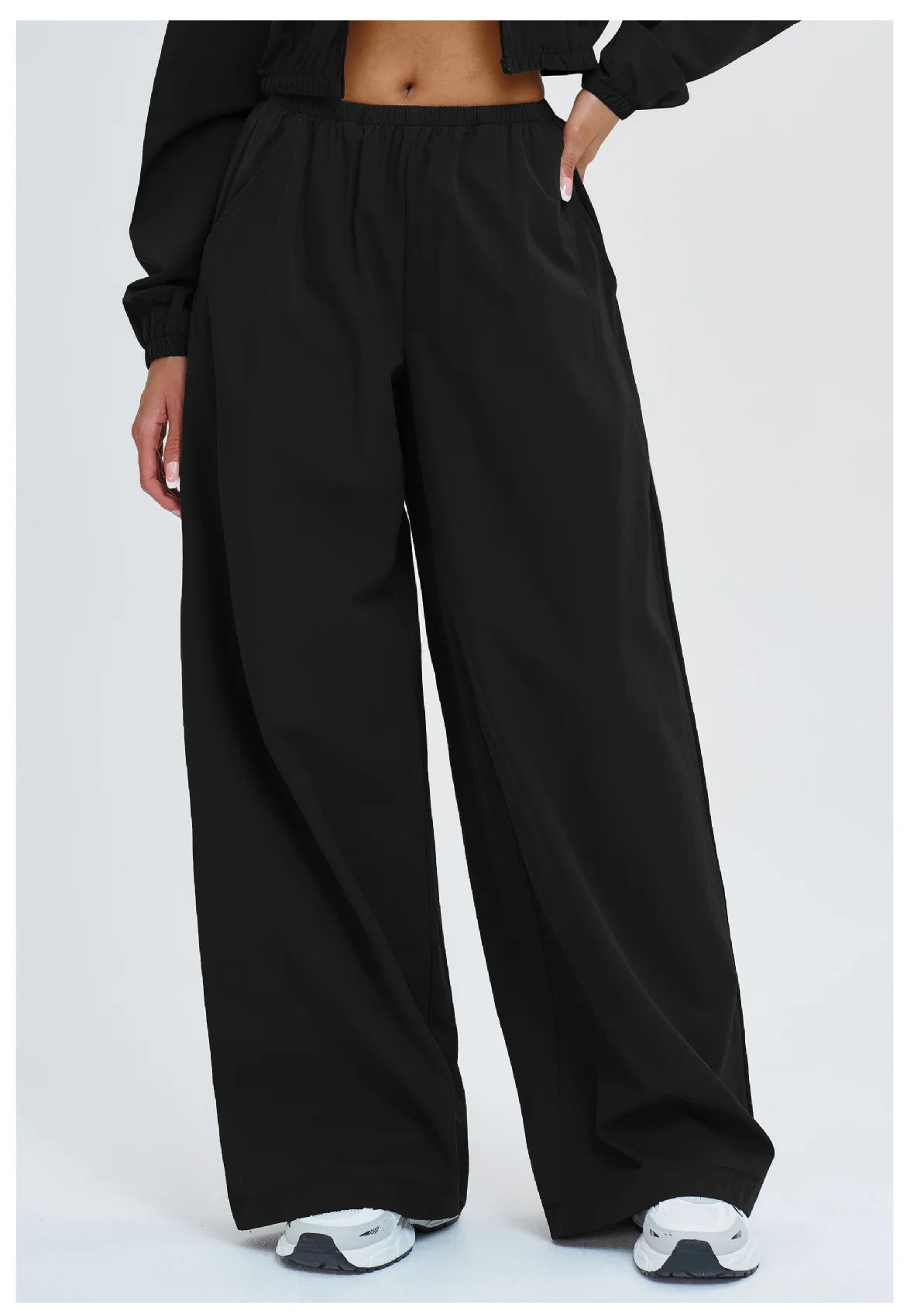 Women’s loose wide-leg yoga pants in black with elastic waistband.