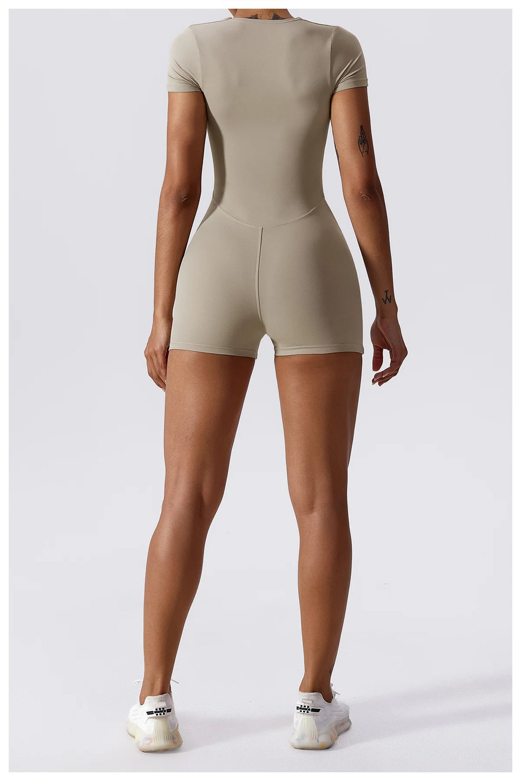 Beige short-sleeve one-piece yoga suit with center back seam and fitted shorts