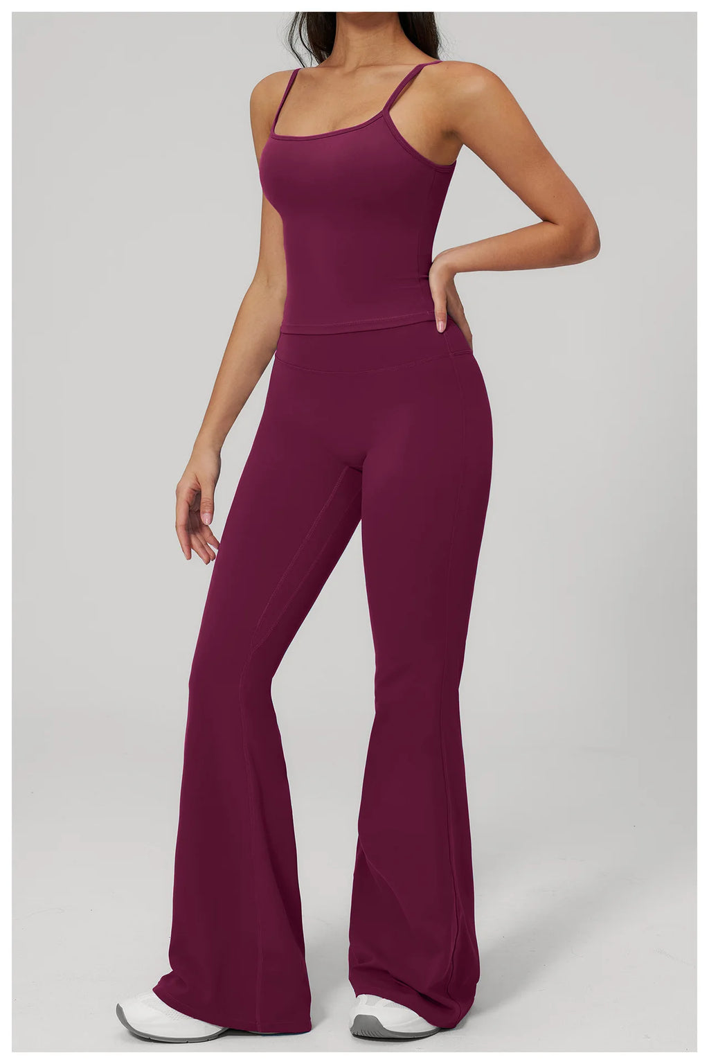 Women's purple sports set, three-quarter view: racerback tank and flared leggings
