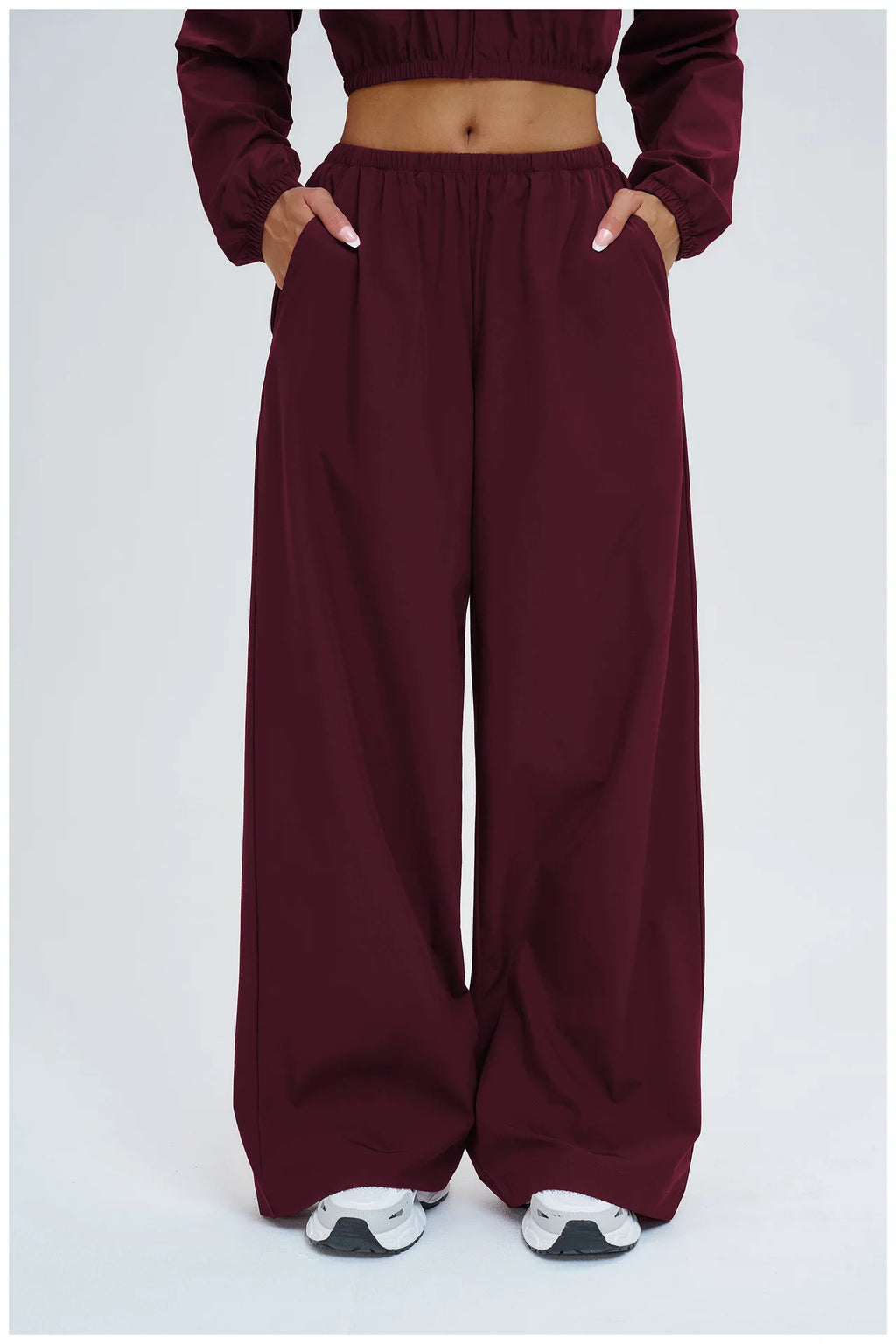 Burgundy wide-leg pants with elastic waistband and relaxed straight legs