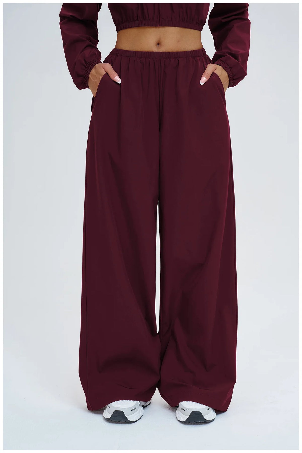 Burgundy wide-leg pants with elastic waistband and relaxed straight legs