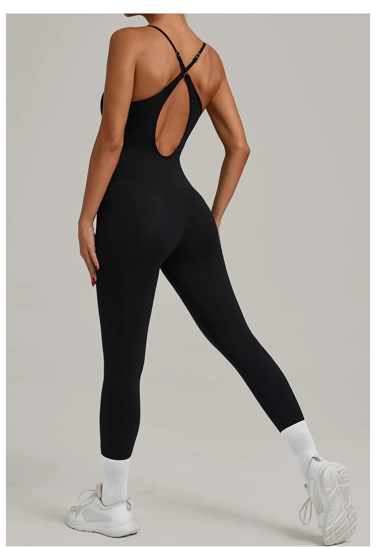 Black yoga jumpsuit with crisscross back straps and oval back cutout