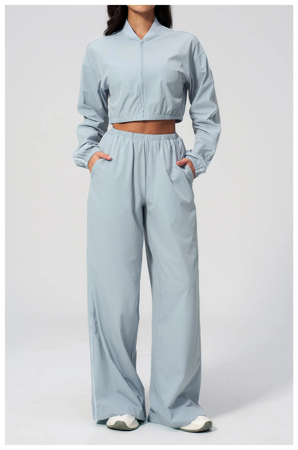 Women’s sky blue cropped zip-up jacket with elastic waistband and wide-leg pants.