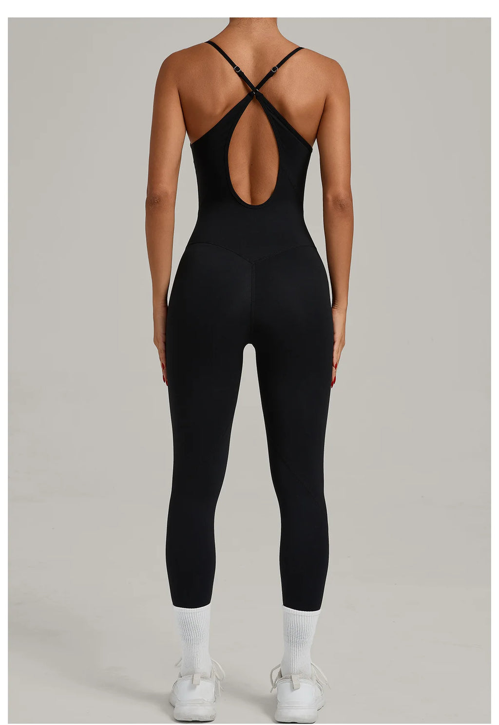 Black yoga jumpsuit with crisscross back straps and oval mid-back cutout